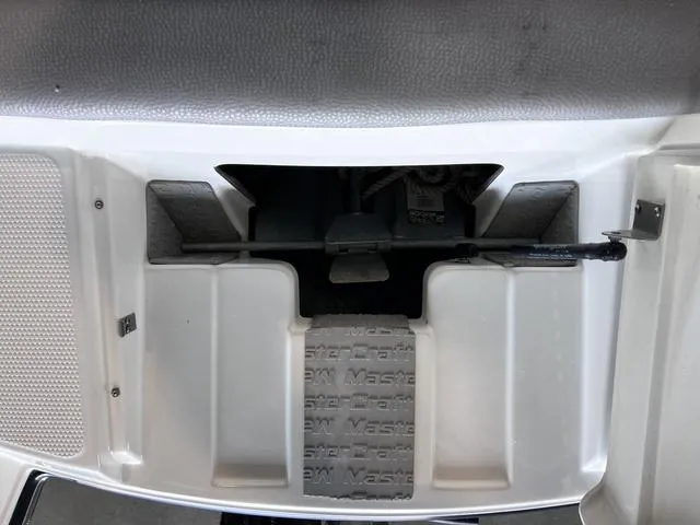 Slide: The Image of 2010 MasterCraft X-Star boat storage compartment with textured flooring. - 29