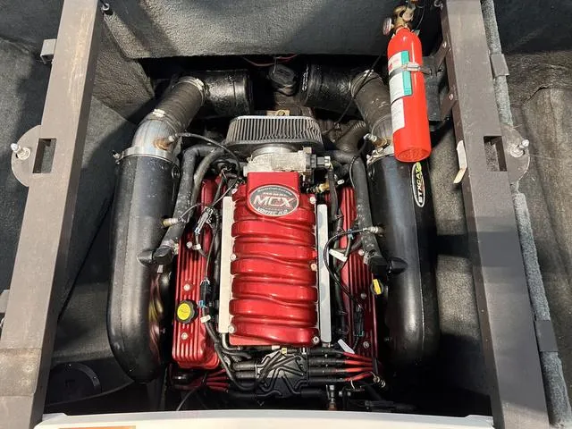 Slide: The Image of 2010 MasterCraft X-Star engine compartment with red engine and fire extinguisher. - 5