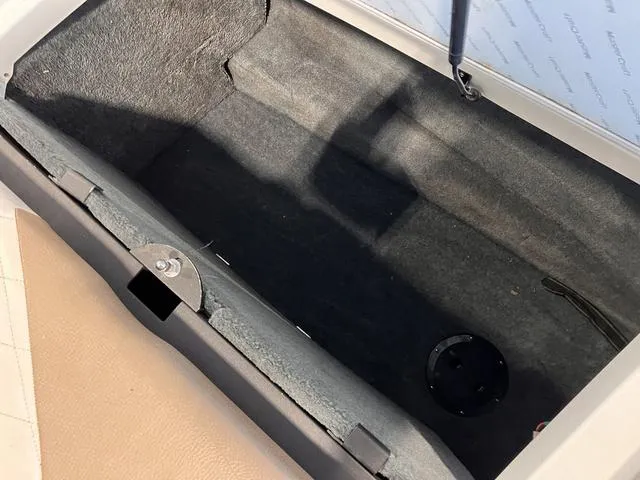 Slide: The Image of Open storage compartment in 2010 MasterCraft X-Star boat. - 6