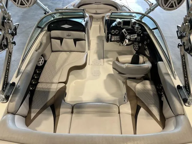 Slide: The Image of 2010 MasterCraft X-Star boat interior with plush seating and modern dashboard. - 7