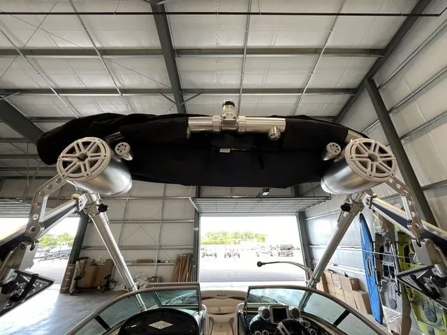 Slide: The Image of 2010 MasterCraft X-Star boat with wakeboard tower and speakers in a storage facility. - 8