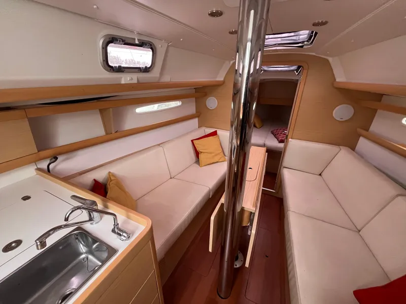 Slide: The Image of Interior of 2012 Beneteau First 30 sailboat with cozy seating and modern amenities. - 12