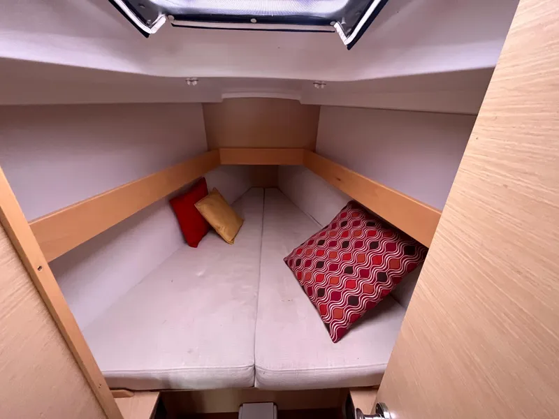Slide: The Image of Cozy cabin interior of 2012 Beneteau First 30 sailboat with colorful cushions. - 13
