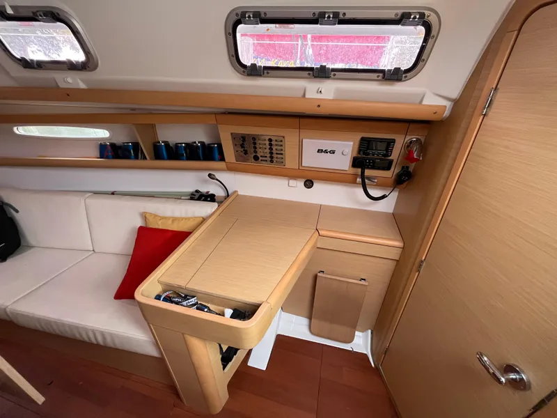 Slide: The Image of Interior of 2012 Beneteau First 30 sailboat with modern wood finish and seating area. - 14