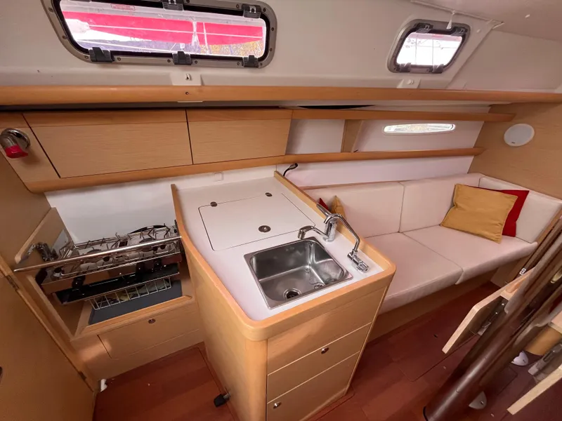 Slide: The Image of Interior of 2012 Beneteau First 30 sailboat with kitchenette and seating area. - 17