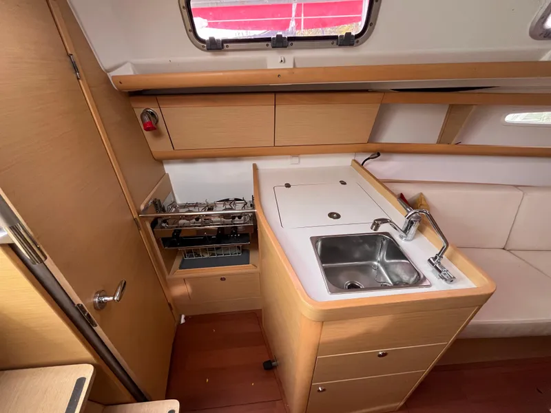 Slide: The Image of Interior of 2012 Beneteau First 30 sailboat with compact kitchen and sink. - 18