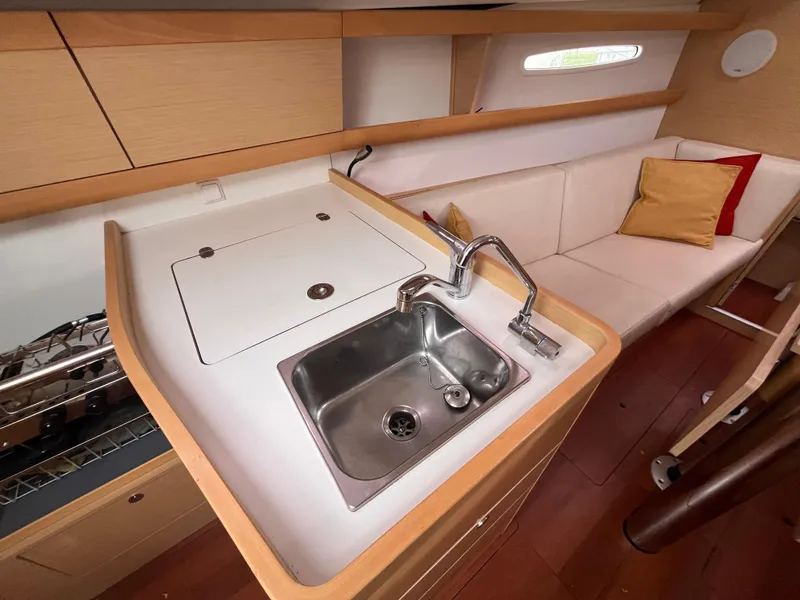 Slide: The Image of Interior of 2012 Beneteau First 30 yacht with sink and seating area. - 19