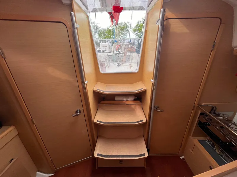 Slide: The Image of Interior of 2012 Beneteau First 30 sailboat with wooden steps and cabinetry. - 20