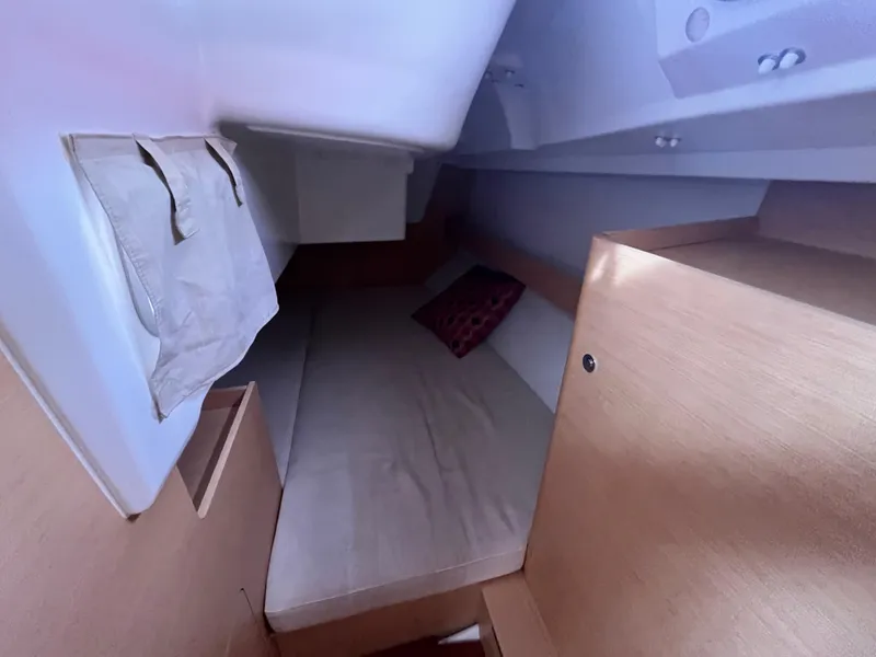 Slide: The Image of Cozy cabin interior of 2012 Beneteau First 30 sailboat with bed and storage. - 21