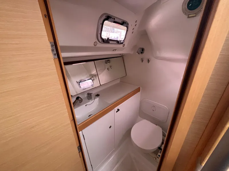 Slide: The Image of Beneteau First 30 yacht bathroom, 2012 model, featuring compact design with sink and toilet. - 22