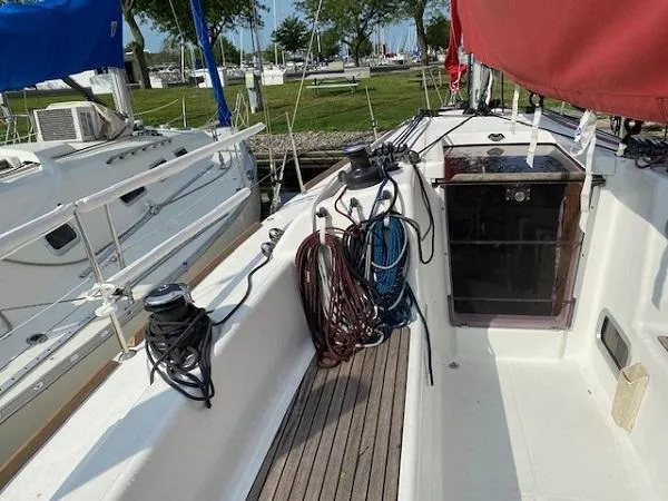 Slide: The Image of 2012 Beneteau First 30 sailboat cockpit with ropes and winches, docked at marina. - 4