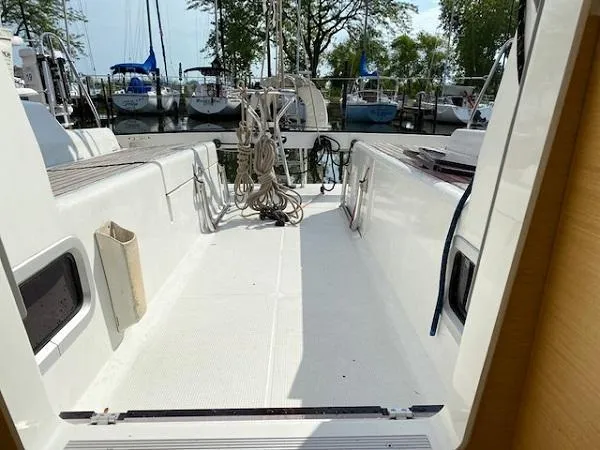 Slide: The Image of Beneteau First 30 sailboat cockpit, 2012 model, docked with visible rigging and marina background. - 6