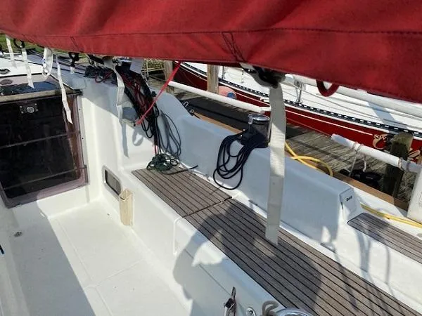 Slide: The Image of 2012 Beneteau First 30 sailboat cockpit with red sail cover and neatly arranged ropes. - 8