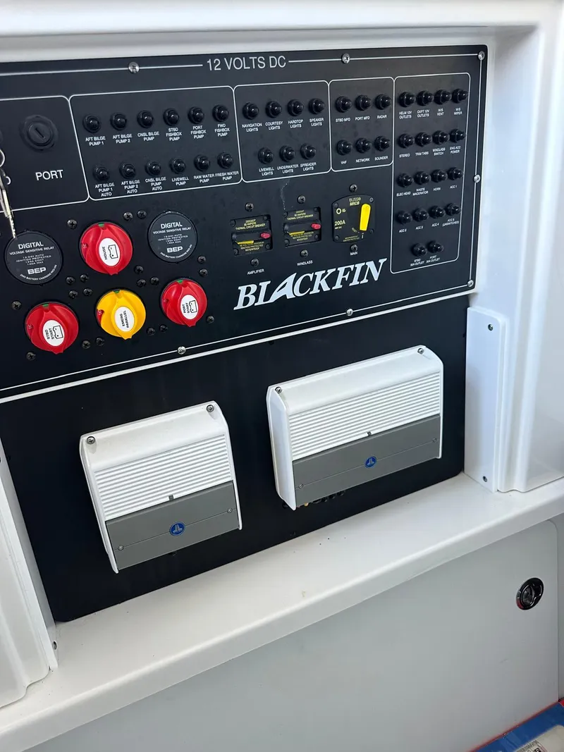 Slide: The Image of 2023 Blackfin 302CC control panel with switches and voltage indicators. - 11