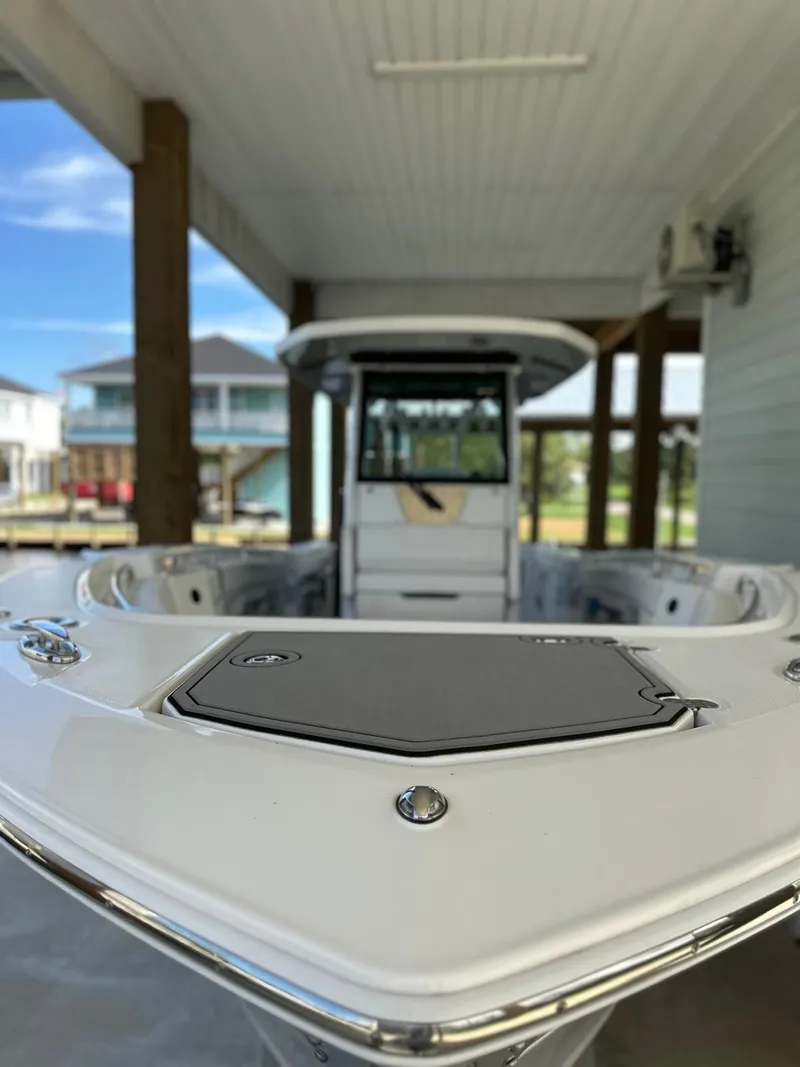 Slide: The Image of 2023 Blackfin 302CC boat docked under a covered structure. - 2