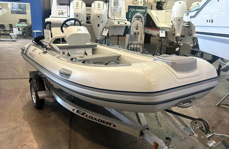 The Image of 2025 Highfield CL380 inflatable boat on trailer in showroom. - 0