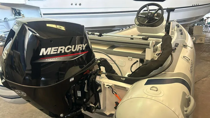 Slide: The Image of 2025 Highfield CL380 boat with Mercury outboard motor in a showroom. - 3