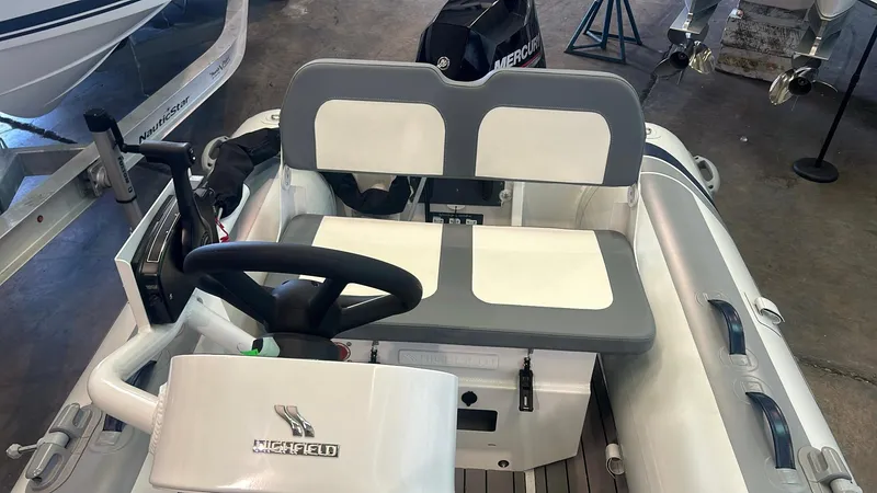Slide: The Image of 2025 Highfield CL380 boat interior with steering wheel and seating. - 5
