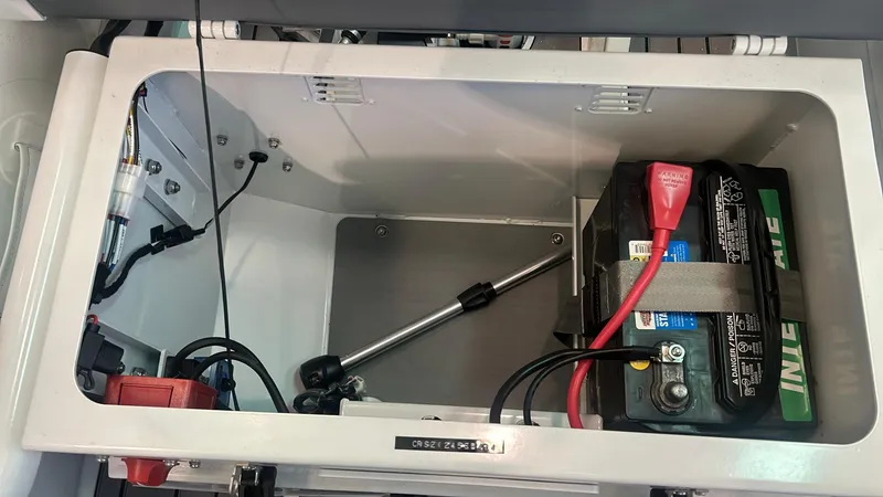 Slide: The Image of Battery compartment of 2025 Highfield CL380 boat, featuring secure battery setup and wiring. - 7
