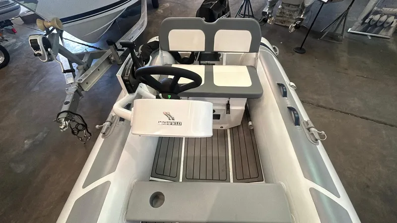 Slide: The Image of 2025 Highfield CL380 inflatable boat interior with steering wheel and seating. - 4