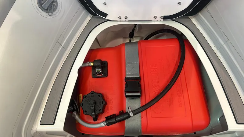 Slide: The Image of Fuel tank compartment of 2025 Highfield CL380 boat, featuring a secured red gasoline container. - 9
