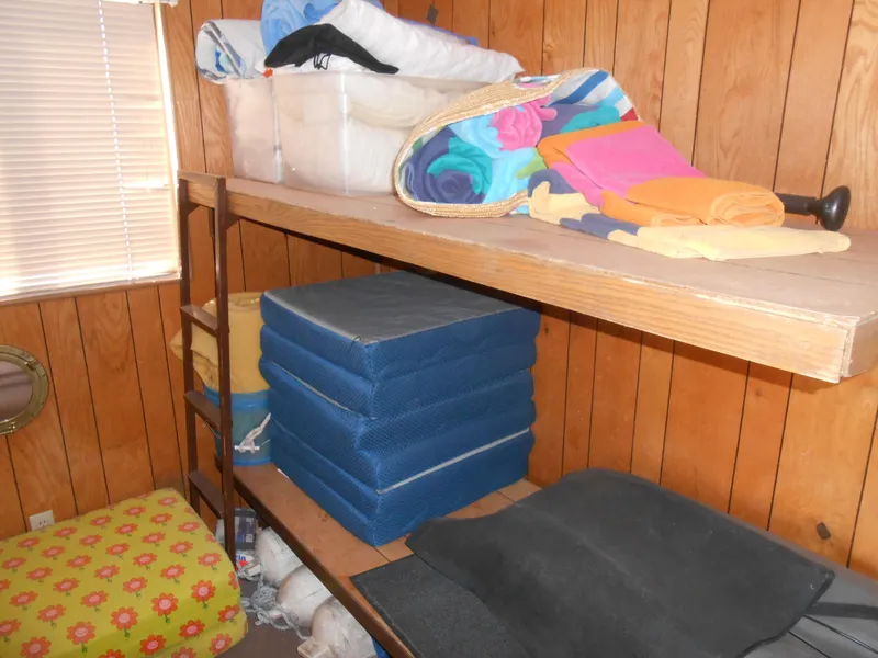 Slide: The Image of Interior of 1986 Hanson houseboat with wooden shelves and colorful cushions. - 20