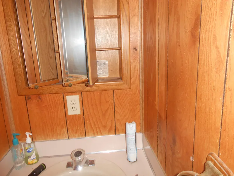 Slide: The Image of Wood-paneled bathroom with open medicine cabinet in 1986 Hanson houseboat. - 23