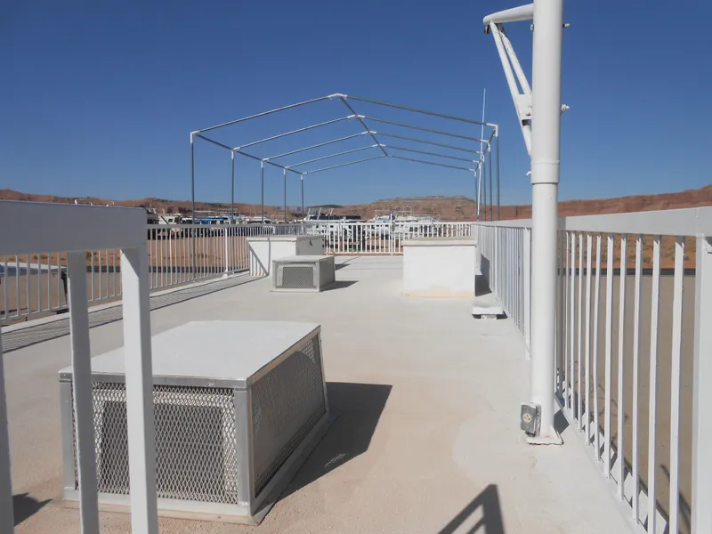 Slide: The Image of Rooftop deck of 1986 Hanson houseboat with metal framework and railings under clear blue sky. - 26