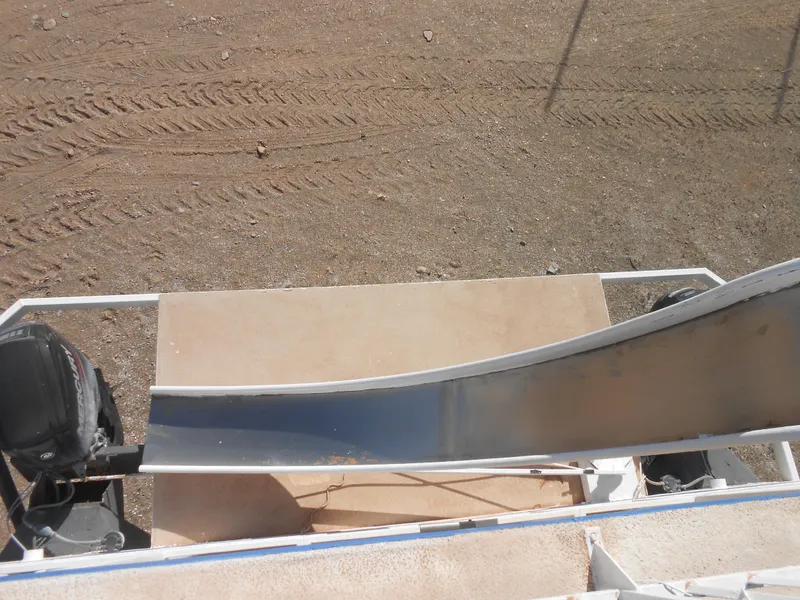 Slide: The Image of 1986 Hanson houseboat with slide, parked on sandy terrain. - 28