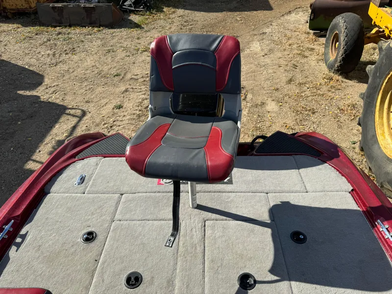 Slide: The Image of 2008 Triton 17 Explorer boat seat with red and black upholstery on a gray deck. - 13