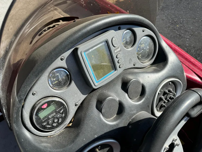 Slide: The Image of Dashboard of a 2008 Triton 17 Explorer boat with gauges and controls. - 14