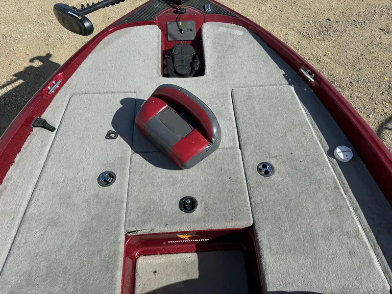 Slide: The Image of 2008 Triton 17 Explorer boat deck with red and gray carpeted surface. - 15