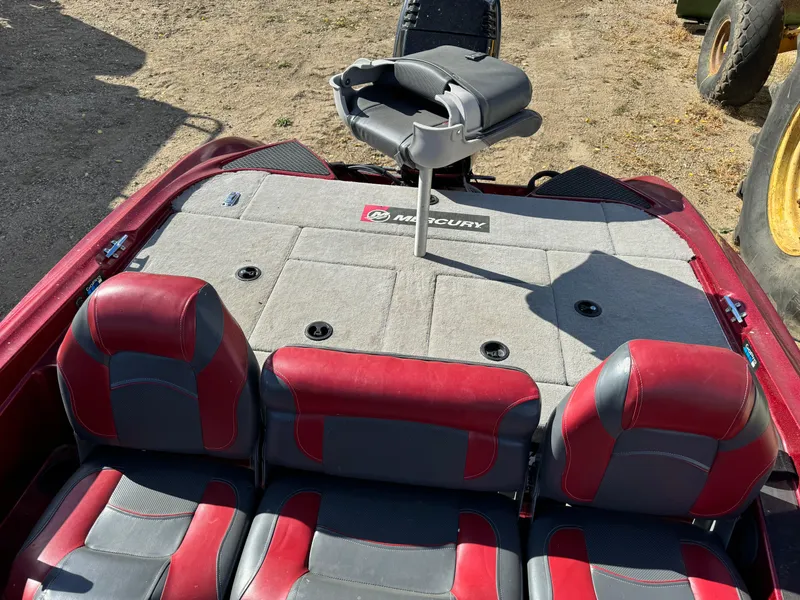 Slide: The Image of 2008 Triton 17 Explorer boat interior with red and gray seating and Mercury branding. - 7