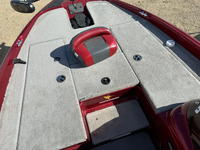 Slide: The Image of 2008 Triton 17 Explorer boat deck with red and gray seating, carpeted surface. - 9