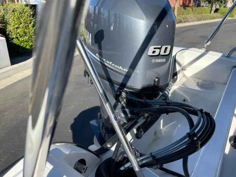 Slide: The Image of Rendova 14 boat with Yamaha 60 outboard motor, 1998 model, parked on street. - 10