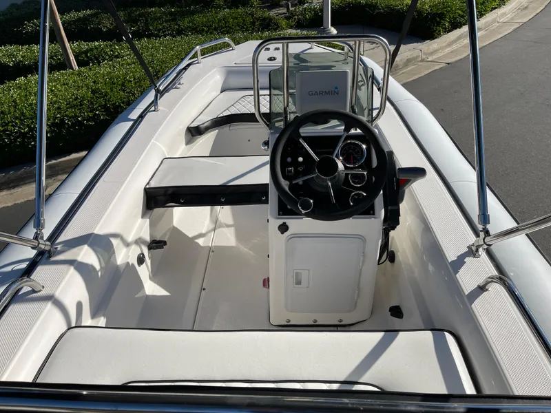 Slide: The Image of 1998 Rendova 14 boat interior with steering console and Garmin navigation system. - 11