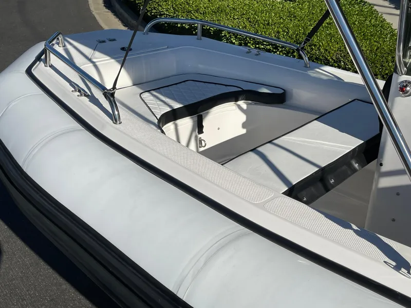 Slide: The Image of 1998 Rendova 14 boat with white seating and sleek design. - 4