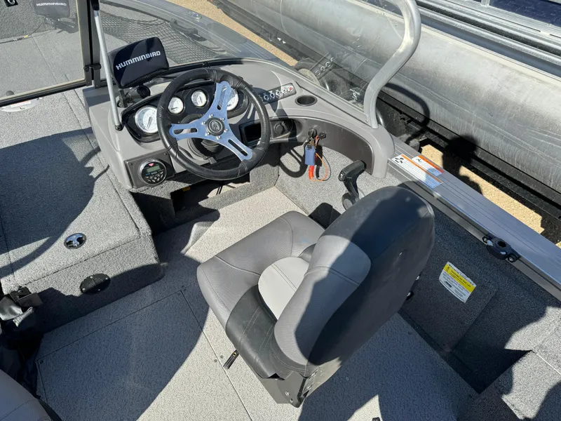 Slide: The Image of 2018 Crestliner 1850 Fish Hawk WT boat interior with steering wheel and seat. - 6