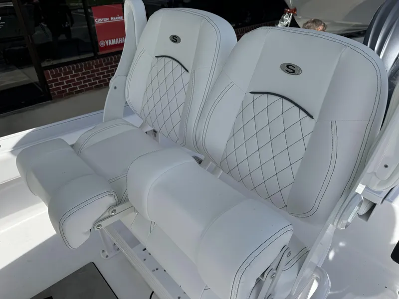 Slide: The Image of 2025 Sportsman Masters 247 Bay Boat seats with diamond stitching and armrests. - 11