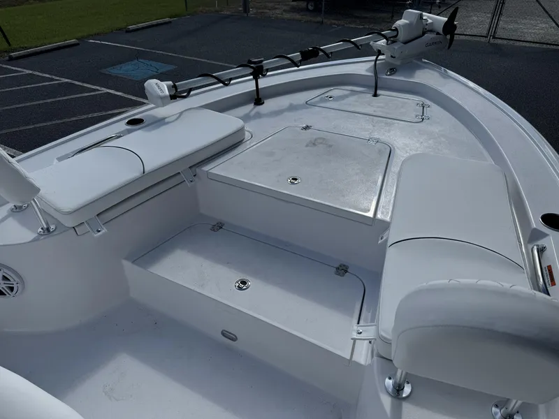 Slide: The Image of 2025 Sportsman Masters 247 Bay Boat interior with seating and storage compartments. - 12