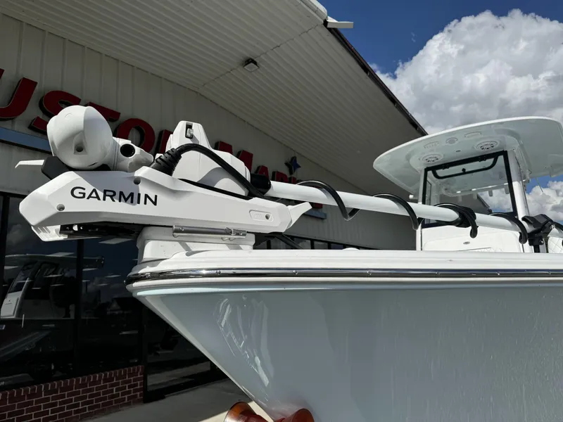 Slide: The Image of 2025 Sportsman Masters 247 Bay Boat with Garmin equipment, displayed outdoors under a cloudy sky. - 6