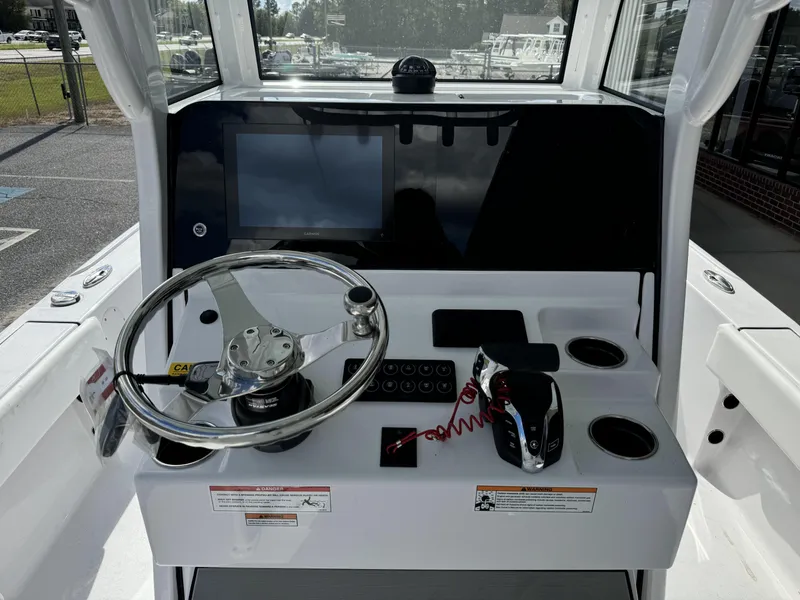 Slide: The Image of 2025 Sportsman Masters 247 Bay Boat dashboard with steering wheel and controls. - 9