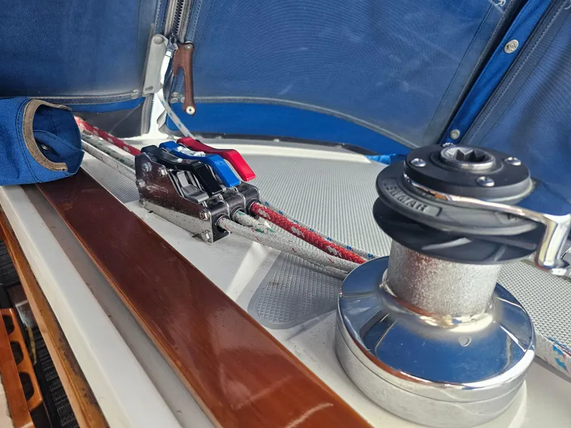 Slide: The Image of Sailing equipment on a 1990 Catalina 42 yacht, featuring winch and rope clutches. - 11