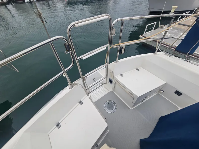 Slide: The Image of Cockpit of a 1990 Catalina 42 sailboat with storage compartments and railing. - 13