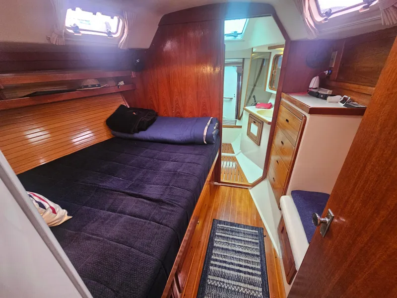Slide: The Image of Cozy cabin interior of 1990 Catalina 42 sailboat with wooden finish and comfortable bedding. - 20