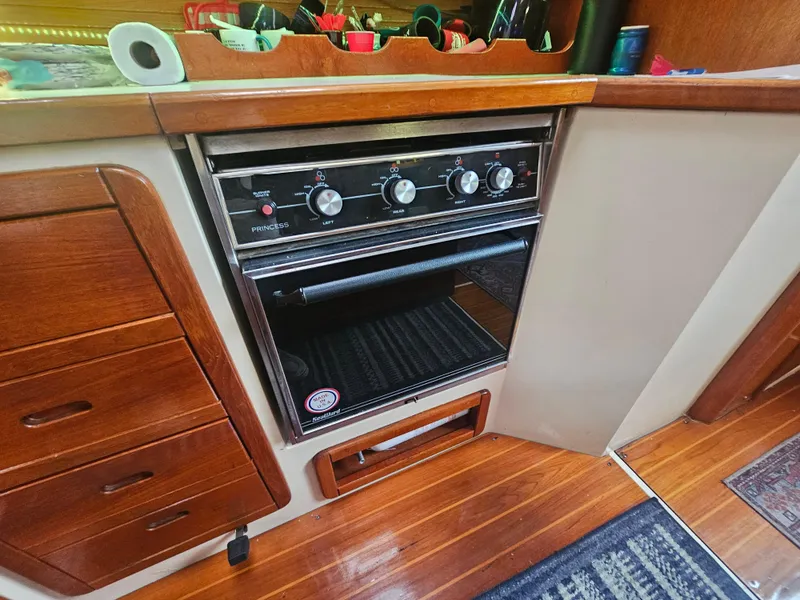 Slide: The Image of Galley kitchen in 1990 Catalina 42 sailboat with stove and wooden cabinetry. - 24