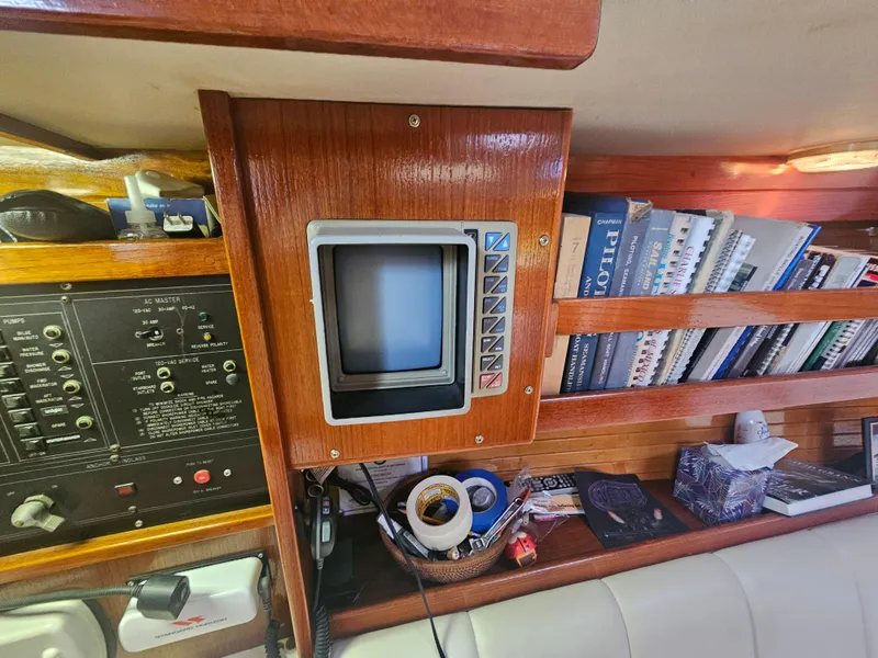 Slide: The Image of Interior of 1990 Catalina 42 sailboat with navigation equipment and bookshelves. - 27