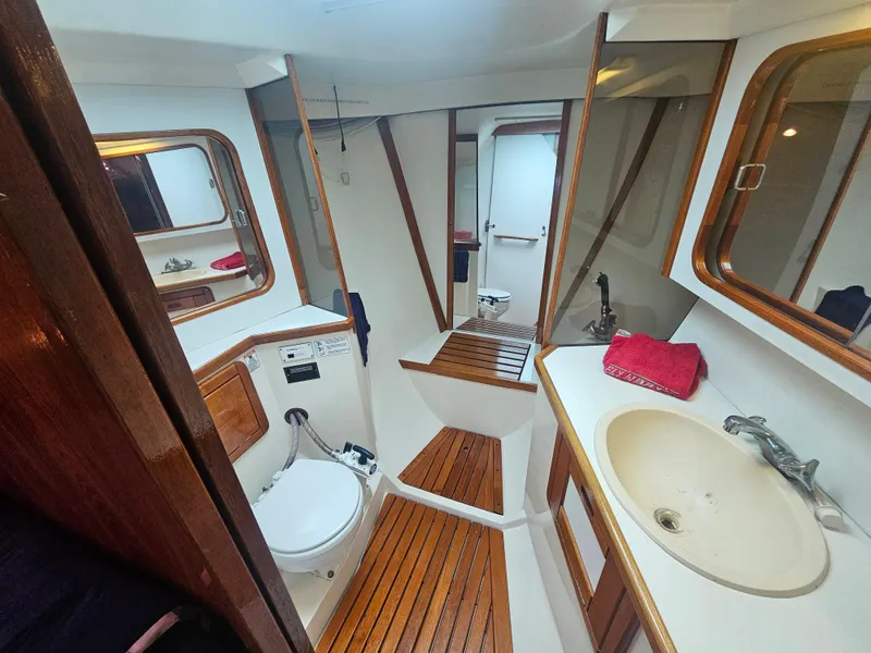 Slide: The Image of Interior of 1990 Catalina 42 sailboat bathroom with wooden accents and modern fixtures. - 29