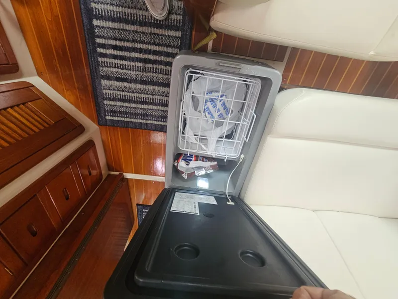 Slide: The Image of Open fridge on 1990 Catalina 42 yacht, showing interior and wooden flooring. - 31