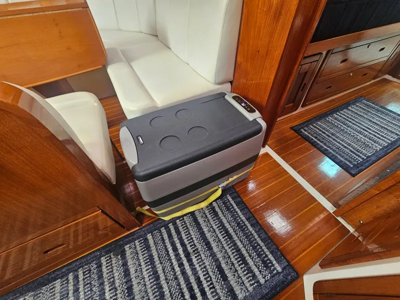 Slide: The Image of Interior of 1990 Catalina 42 yacht with cooler and wooden flooring. - 32